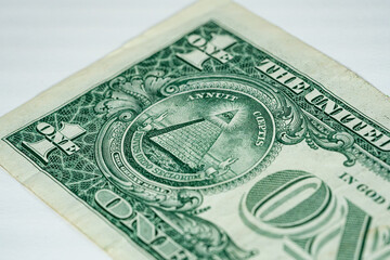 Sideways macro of big letters ONE with pyramid on one dollar US America currency bill on white background 2