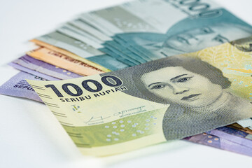 Stack of indonesian Rupiah bank notes with thousand Rupiah in focus