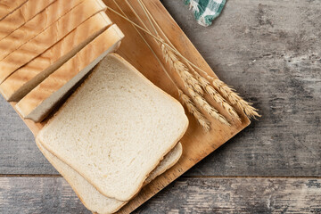 Sliced of White Bread on wooden table. Top view. Copy space