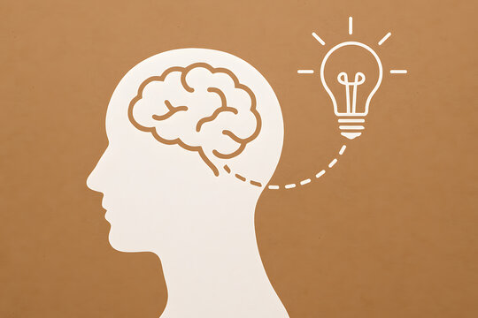 Illumination of the Mind: A thought-provoking illustration of a human profile, a glowing light bulb symbolizes the spark of innovation and the brilliance of ideas.