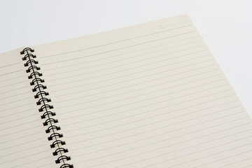 Lined Notebook Page with Spiral Binding on White Background – Angled View
