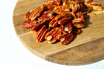 Delicious salted pecan nuts scattered.