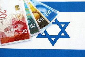Israel New Shekels banknotes on national flag. The current Israel money bills lies on flag in big...