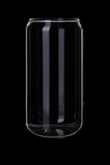 Empty thin glass beverage jar on black background