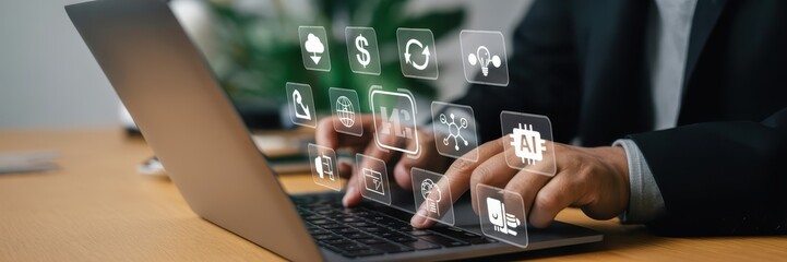 Person working on a laptop with digital interface overlays.