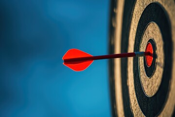 Bullseye target with red dart under a dark blue sky, symbolizing achievement and focus