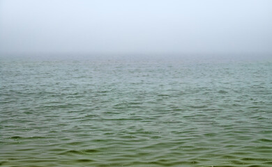 Foggy sea at sunrise, nebulosus. Calm weather before the afternoon breeze