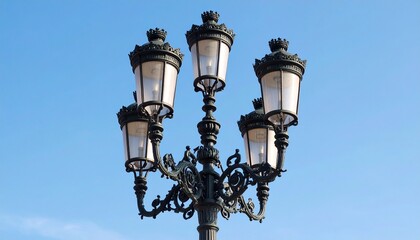Vintage street lamp on blue sky.
