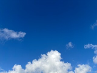 Beautiful blue sky with white clouds. The sky was clear and bright, and clouds were scattered all...