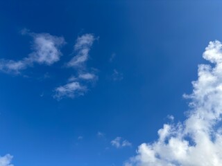 Beautiful blue sky with white clouds. The sky was clear and bright, and clouds were scattered all over the sky. The scene was peaceful and serene, as if the viewer was gazing at a beautiful day