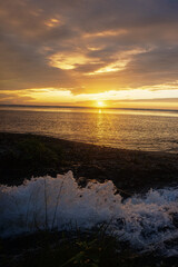 Fototapeta premium Sunset fierce sun along coast of Sea of Japan. Sakhalin. Beach. The stream where salmon spawn