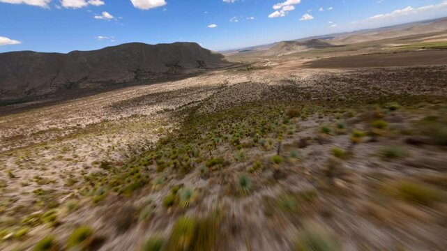 FPV DRONE SHOT OF A MOUNTAIN AND VALLEY IN THE DESERT OF COAHUILA IN MEXICO