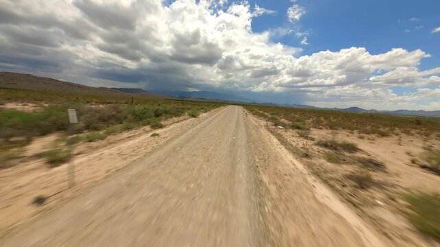 DYNAMIC FPV DRONE SHOT OF A ROAD IN THE MIDDLE OF THE DESERT IN MEXICO