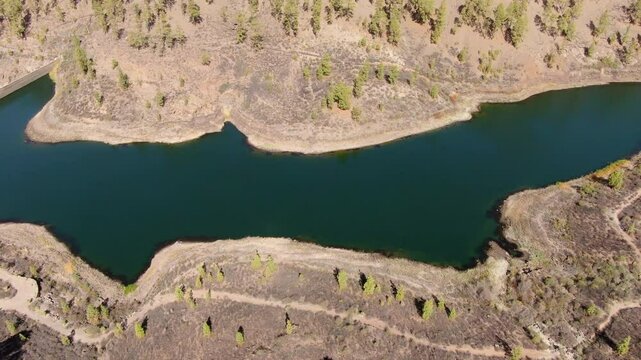 Breathtaking aerial perspective of El Mulato Dam nestled in the arid landscape of Gran Canaria