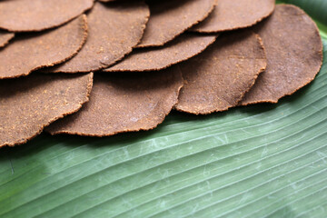 Fermented soybean discs, known as “Thua Nao,” a traditional Thai seasoning used to enhance flavor in Northern cuisine.