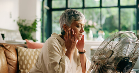 Senior woman, hot and fan at house for heatwave, air conditioning and menopause symptoms. Elderly...