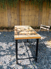 Rustic Wooden Table in Quaint Garden Cafe.