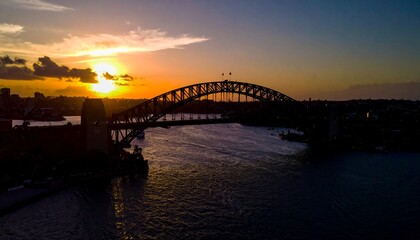 Fototapeta premium Stunning Sunset Silhouette of Iconic Bridge over Water