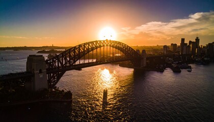 Fototapeta premium Stunning Sunrise over Iconic Steel Arch Bridge and City Skyline