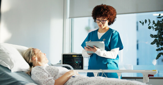 Hospital bed, medical and woman with nurse for consultation with tablet for treatment plan. Digital technology, checkup and female patient with healthcare worker for diagnosis in clinical ward. - Powered by Adobe