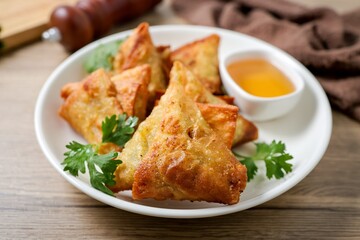 Samosas in a white plate on wooden background ,indian fried samosa, indian snack