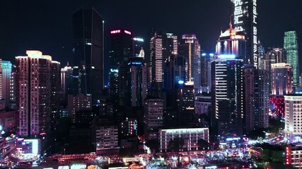 Captivating cityscape reveals illuminated skyscrapers of Yuzhong Peninsula, Chongqing, China at night with active city streets below