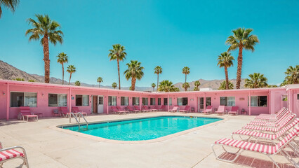 Pink retro motel and pool under sunny skies