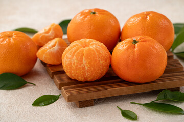 Fresh juicy small tangerine mandarin orange on white table background.