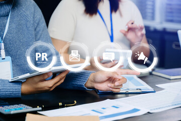 PR, Public relations concept. hands using laptop and tablet with public relations icon for...
