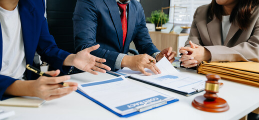 Business and lawyers discussing contract papers with brass scale on desk in office. Law, legal...