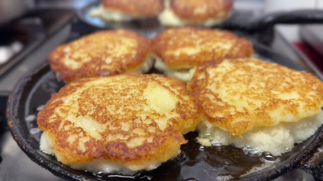 Preparation potato pancake on frying pan, draniki