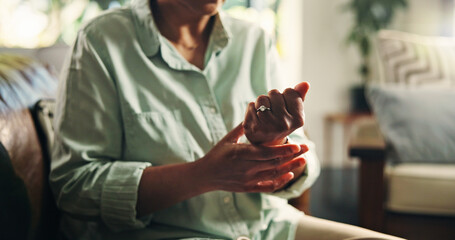 Wrist pain, hands and injury with old woman on sofa for osteoporosis, arthritis and emergency....