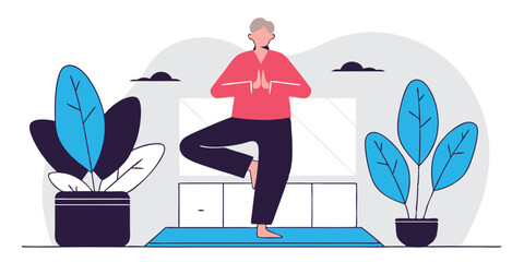 Woman practicing yoga in the tree pose with plants nearby indoors