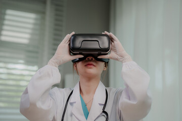 A female medical professional in a lab coat and stethoscope uses a VR headset, interacting with...