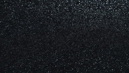 Obraz premium A shimmering black background with glittering particles, creating a mesmerizing and elegant effect.