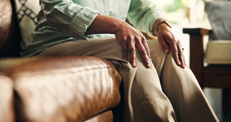 Knee pain, hands and arthritis with old woman on sofa for osteoporosis, injury and emergency....