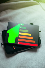 Energy efficiency concept. Laptop top view with energy efficiency rating for energy efficient house. Future is green.