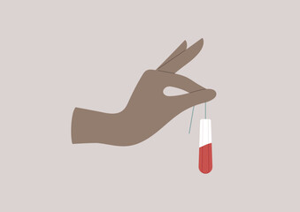 A hand delicately holds a tampon soaked with blood, symbolizing the importance of hygiene in a monthly menstrual cycle