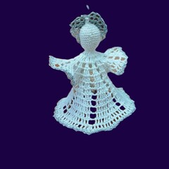 Crocheted white angel on dark blue background