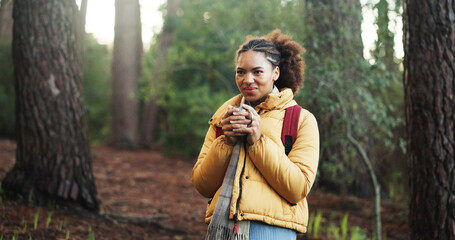 Fototapeta premium African woman, coffee and hiking in jungle for cold morning, travel and trekking adventure. Smile, female person and warm beverage for backpacking, enjoy aroma and reflection for sightseeing in woods