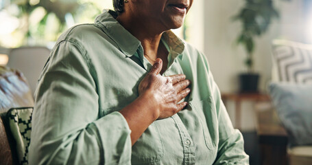 Living room, chest pain and senior woman with heart attack, health risk or angina with medical...