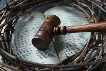 Judge's gavel, crown of thorns and Bible on table, closeup
