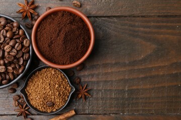 Different types of instant coffee, beans and spices on wooden table, flat lay. Space for text
