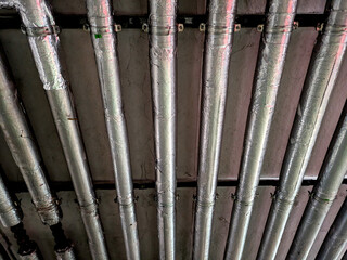 Industrial Metal Pipes on the Walls in a Car Park Building