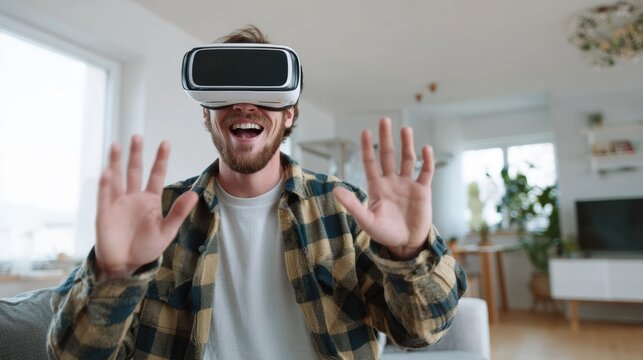 A joyful man enjoys virtual reality with a VR headset, immersed in a digital world filled with excitement.