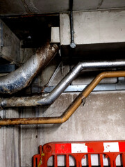 Industrial Metal Pipes on the Walls in a Car Park Building