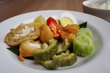 Delicious Indonesian Siomay: steamed fish dumplings served with rich peanut sauce, often with...
