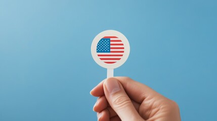 Patriotic Participation, a close-up view of a hand grasping a circular sticker featuring a vibrant election-themed design, showcasing civic engagement