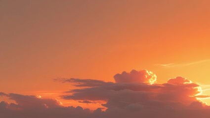 Obraz premium Warm golden light illuminates the vast sky, painting the beautiful clouds in hues of orange and red at dusk