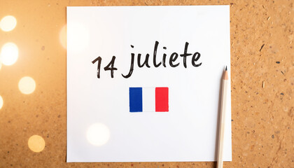 Celebration of Bastille Day with handwritten note and French flag  